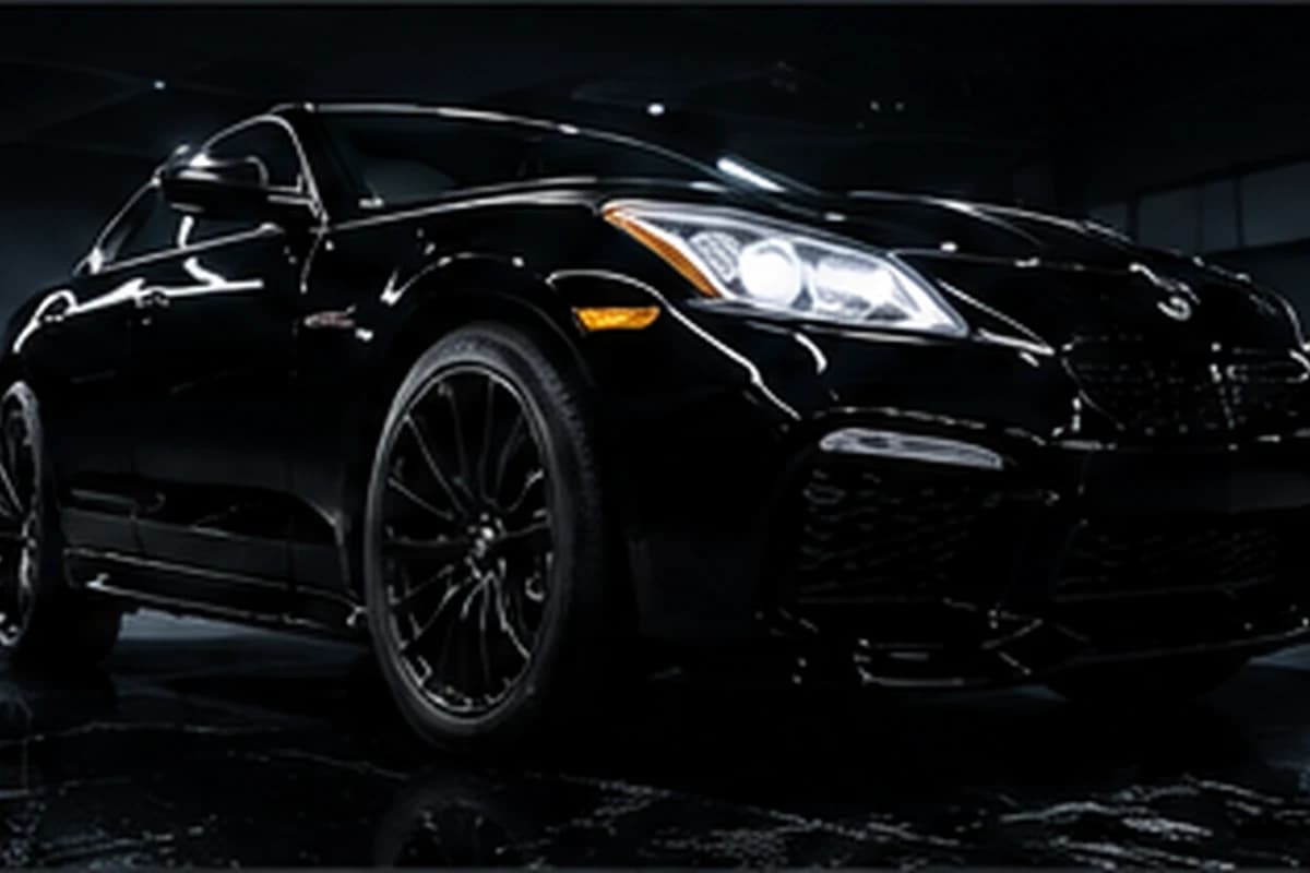 Ceramic-coated black coupe gleaming under studio light